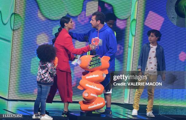 YouTuber Lilly Singh presents Adam Sandler with Favorite male voice from an animated movie award for "Hotel Transylvania 3" on stage during the 32nd...