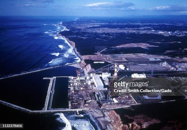 Aerial view of the Fukushima Daiichi Nuclear Power Plant, straddling the Pacific Ocean coastline, Fukushima, Japan, 1971. Image courtesy US...