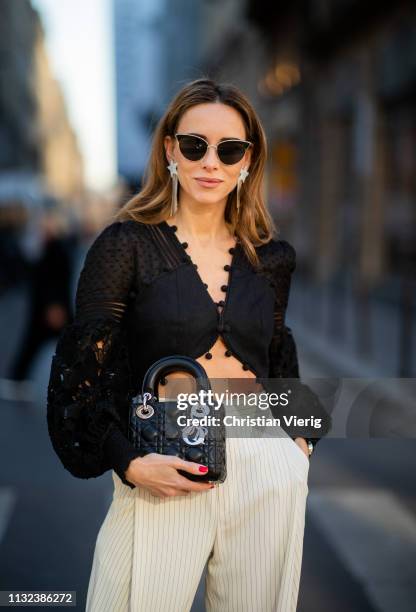 Alexandra Lapp is seen wearing a Corsage Embellished Bodice in black from Zimmermann, black and white striped high-waist 7/8 length pants from Chloé,...