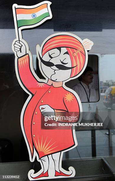 An employee is seen behind the ticket window of India's flagship carrier Air India displaying its logo the "Maharaja" at the domestic airport in...