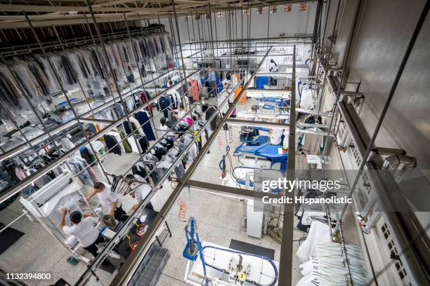 people working at an industrial laundry service - dry cleaning stock pictures, royalty-free photos & images