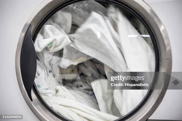 close up of industrial washing machine at a laundromat - clean laundry stock pictures, royalty-free photos & images