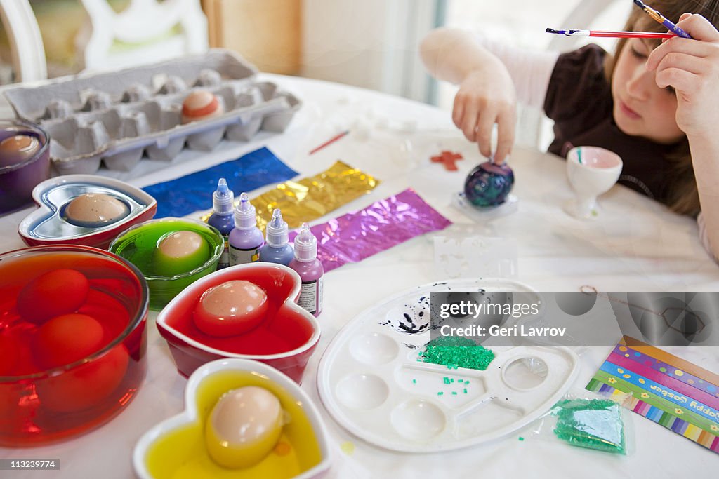 Girl painting eggs