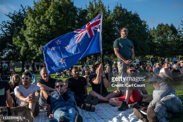 Man holds a New Zealand flag as he and others take part in a vigil to remember the victims of the Christchurch mosque attacks, on March 24, 2019 in...