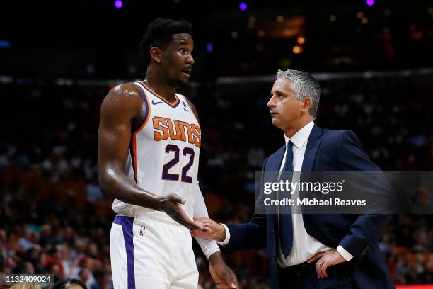 Deandre Ayton of the Phoenix Suns talks with head coach Igor Kokoskov against the Miami Heat during the first half at American Airlines Arena on...