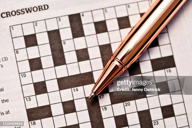 crossword puzzle and pen - word puzzle stock pictures, royalty-free photos & images