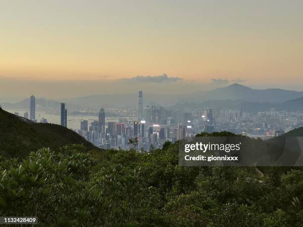 hong kong cityscape at dusk from violet hill - tai tam country park stock pictures, royalty-free photos & images