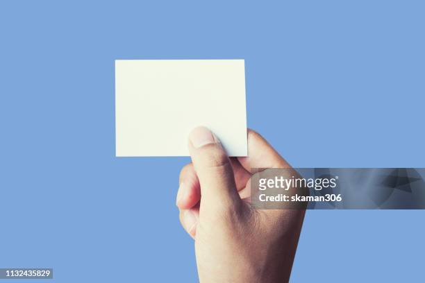 hand touching blank notepad with pastel color background - notepad table stock pictures, royalty-free photos & images
