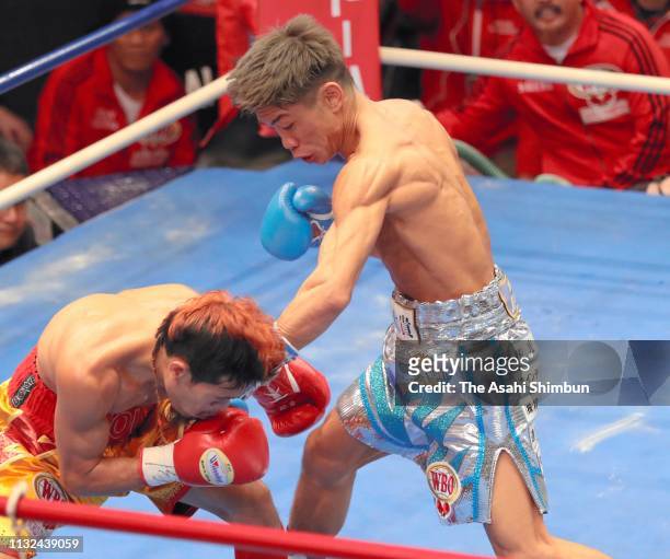 Challenger Masataka Taniguchi of Japan connects his left on champion Vic Saludar of the Philippines in the 2nd round during the WBO Minimumweight...