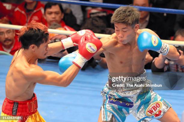 Challenger Masataka Taniguchi of Japan connects his left on champion Vic Saludar of the Philippines in the 1st round during the WBO Minimumweight...