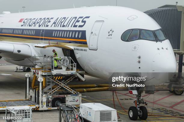 Singapore Airlines Airbus A350-900 with registration 9V-SMB getting loaded for departure as seen from the airport terminal in Amsterdam Schiphol...