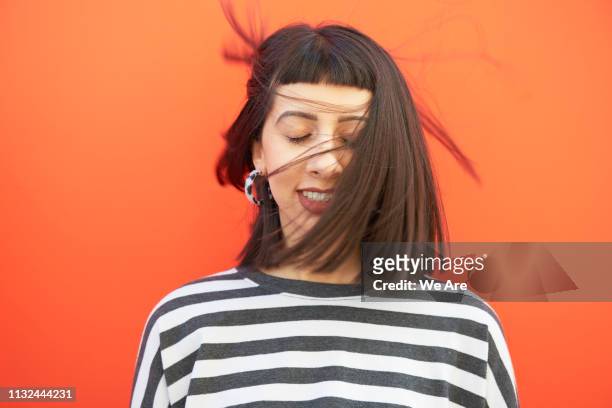 portrait of woman with hair sweeping over face. - eyes closed smile stock pictures, royalty-free photos & images