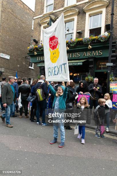 Kid seen holding onto a hanging anti Brexit banner during the protest. Over one million protesters gathered at the People's Rally in London demanding...