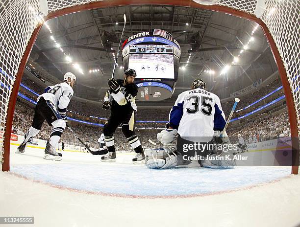 Dwayne Roloson of the Tampa Bay Lightning protects the net as Mike Rupp of the Pittsburgh Penguins and Adam Hall battle in front during Game Seven of...