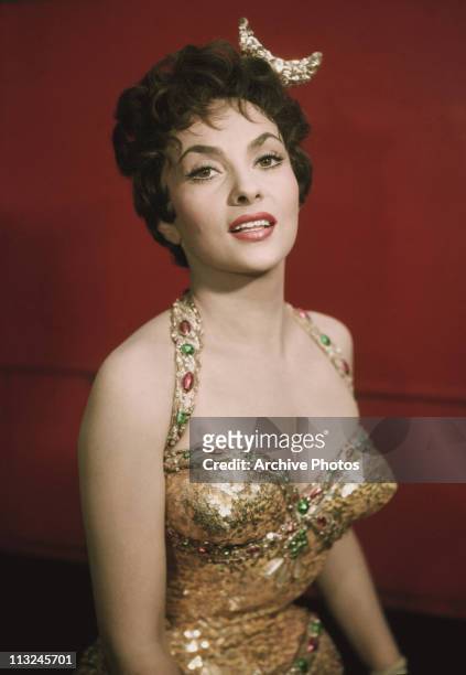 Portrait of Italian actress Gina Lollobrigida in a jewelled gold dress circa 1960.