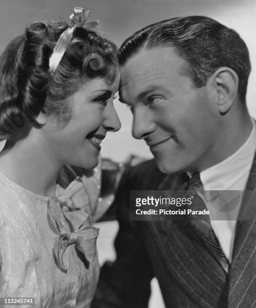 American actress Gracie Allen and her husband actor George Burns with their foreheads touching in 1941.