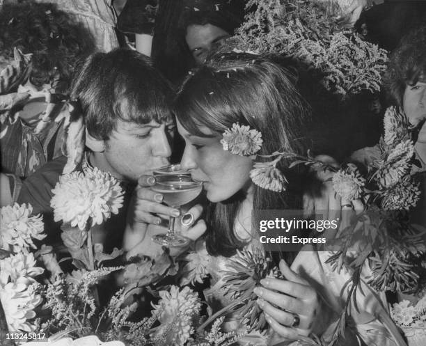 Animals singer Eric Burdon drinking a toast with his new wife Angie King at their wedding reception in London, England on September 07, 1967.