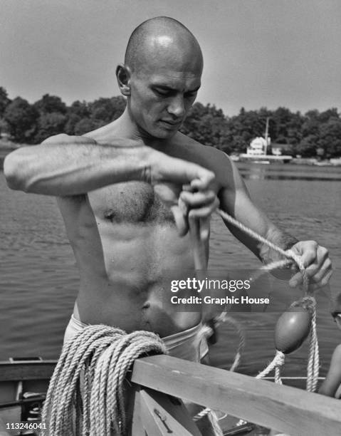 Actor Yul Brynner on a boat at his home in Norwalk, Connecticut in 1957.