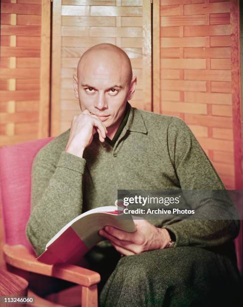 Portrait of actor Yul Brynner with a script circa 1960.