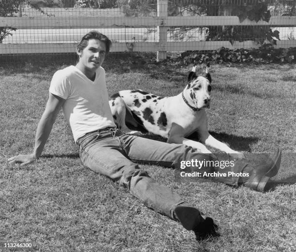 Portrait of American actor James Brolin at home with a dog on his Appytime ranch in California circa 1970.