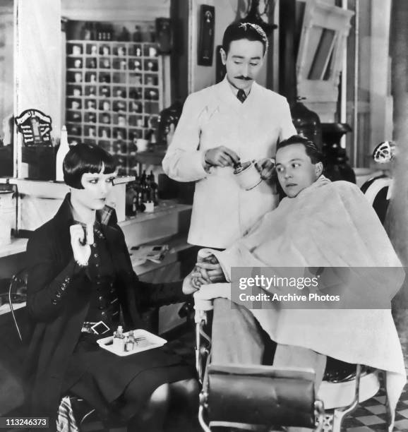 American actress Louise Brooks with Adolphe Menjou as the barber in the 1926 silent film 'A Social Celebrity'.