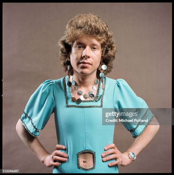Rob Davis of English glam rock band Mud, studio portrait, wearing dress, necklace and earrings, London, 1975.