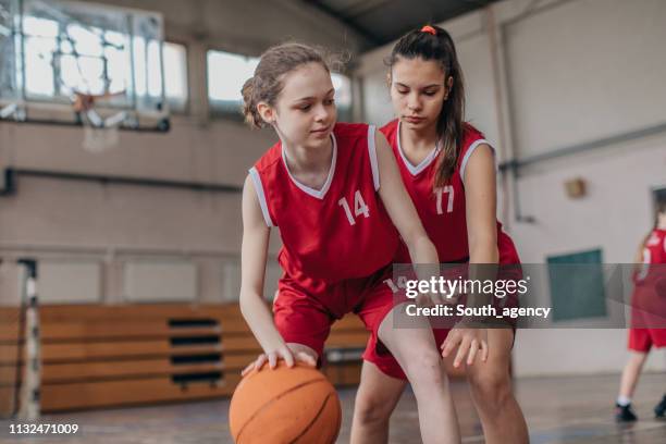 two young girls in basketball duel - basketball league stock pictures, royalty-free photos & images