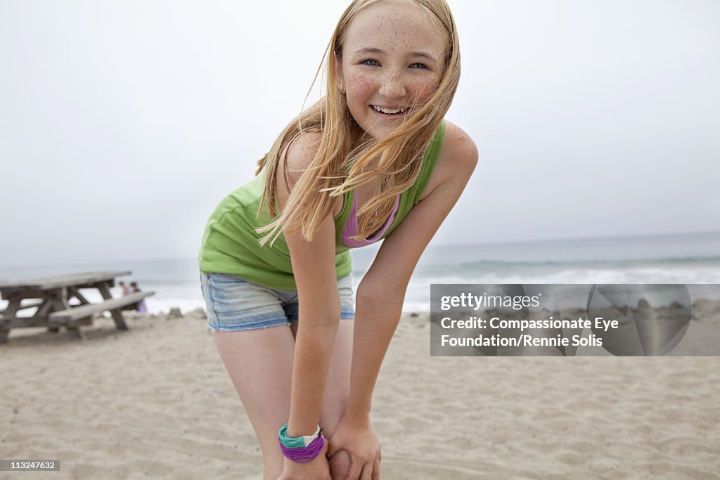 Smiling blonde teenage girl on the beach