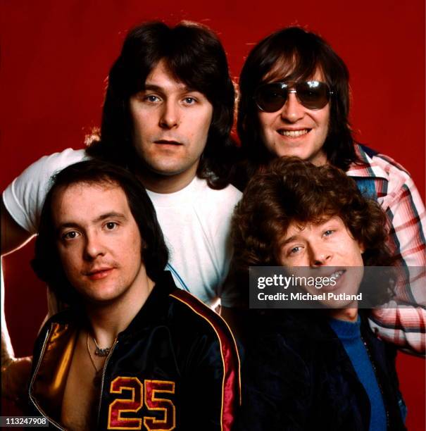 English glam rock band Mud, studio group portrait, London clockwise from bottom left Dave Mount, Ray Stiles, Les Gray, Rob Davis.