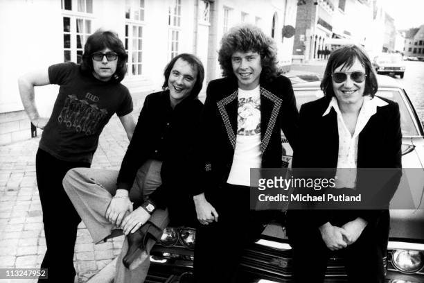 English glam rock band Mud, studio group portrait, London, August 1974, L-R Ray Stiles, Dave Mount, Rob Davis, Les Gray.