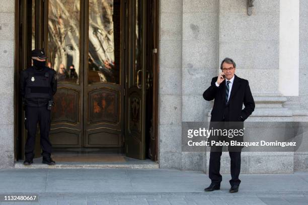 Former Catalan President Artur Mas speaks on the phone as he leaves the Supreme Court during the trial of Catalan separatist leaders on February 27,...