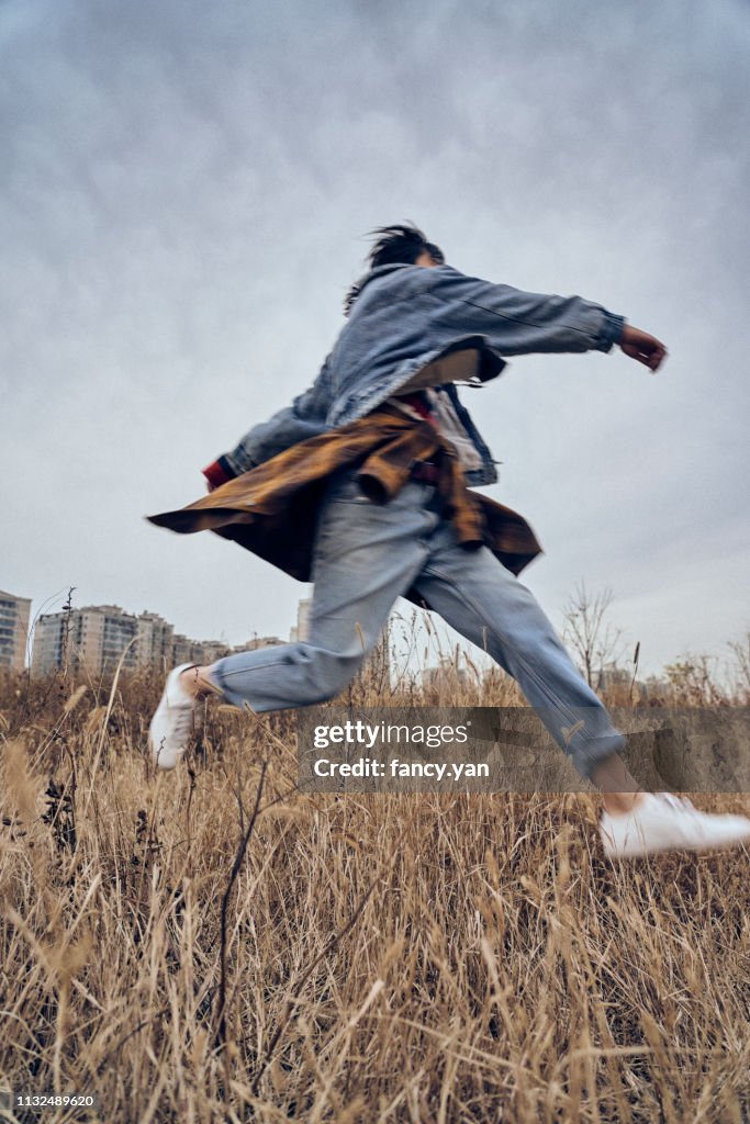 Young woman traveller running in a park