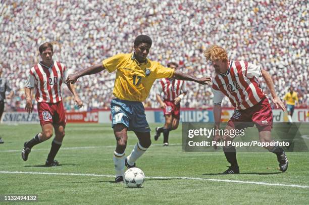 Mazinho of Brazil pictured with the ball as Alexi Lalas and Paul Caligiuri move in during play between Brazil and United States in their 1994 FIFA...