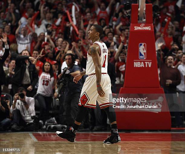 Derrick Rose of the Chicago Bulls smiles as he walks off of the court as fans cheer during a time-out against the Indiana Pacers in Game Five of the...