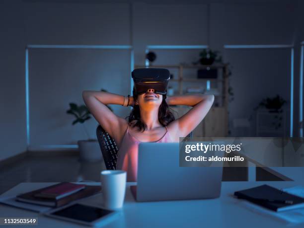smiling business female using virtual reality goggles - 2018 futures game stock pictures, royalty-free photos & images