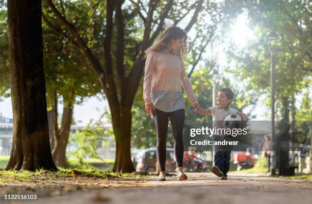 happy mother taking her son to school - soccer mom stock pictures, royalty-free photos & images