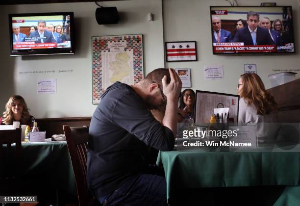 Patrons at Duffy’s Irish Pub view congressional testimony by U.S. President Donald Trump’s former attorney and fixer, Michael Cohen, during a “watch...