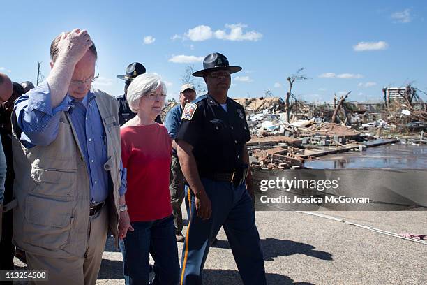 In the aftermath of Wednesday night's storms, Alabama Gov. Robert Bentley and his wife, Dianne, walk through a destroyed area near the University of...