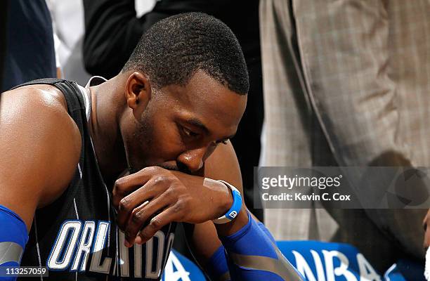 Dwight Howard of the Orlando Magic sits on the bench during a timeout before the final seconds against the Atlanta Hawks during Game Six of the...