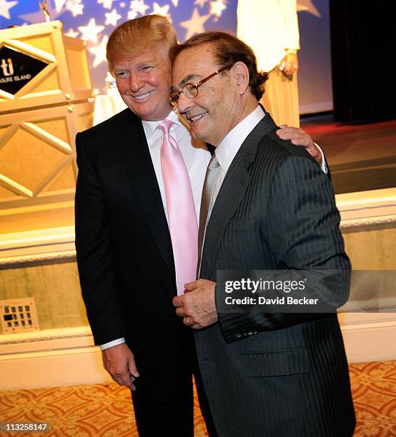Chairman and President of the Trump Organization Donald Trump poses with Treasure Island Hotel & Casino owner Phil Ruffin after speaking to several...