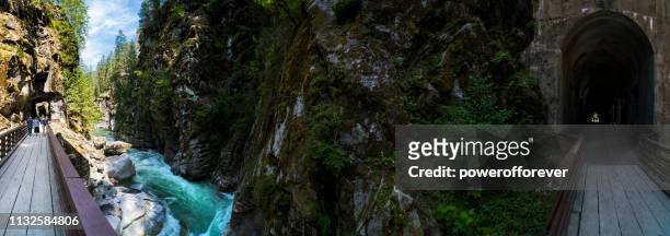 panoramic of othello tunnels at coquihalla canyon provincial park in the canadian rocky mountains of british columbia, canada - othello stock pictures, royalty-free photos & images