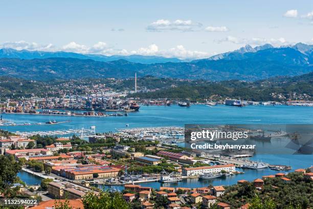 view of the military, commercial dock and ships with mountains of la spezia in italy - la spezia stock pictures, royalty-free photos & images