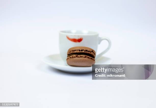 cup of coffee with lipstick stain and macaroon snack - lipstick stain stock pictures, royalty-free photos & images