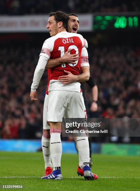 Henrikh Mkhitaryan of Arsenal celebrates after scoring his team's second goal with Mesut Ozil of Arsenal during the Premier League match between...