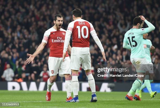 Henrikh Mkhitaryan of Arsenal celebrates with teammate Mesut Ozil after scoring his team's second goal during the Premier League match between...