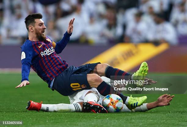 Casemiro of Real Madrid competes for the ball with Lionel Messi of Barcelona during the Copa del Rey Semi Final second leg match between Real Madrid...