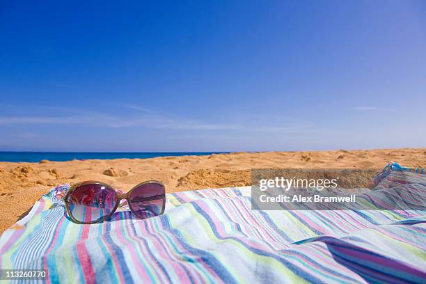 sunglasses and beach - beach towel stock pictures, royalty-free photos & images