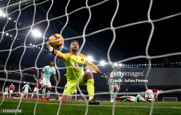 Artur Boruc of AFC Bournemouth attempts to save the ball as Laurent Koscielny of Arsenal scores his team's third goal during the Premier League match...