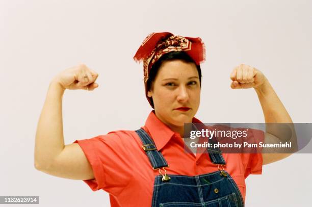 rosie the riveter inspired studio shot - rosie the riveter stock pictures, royalty-free photos & images