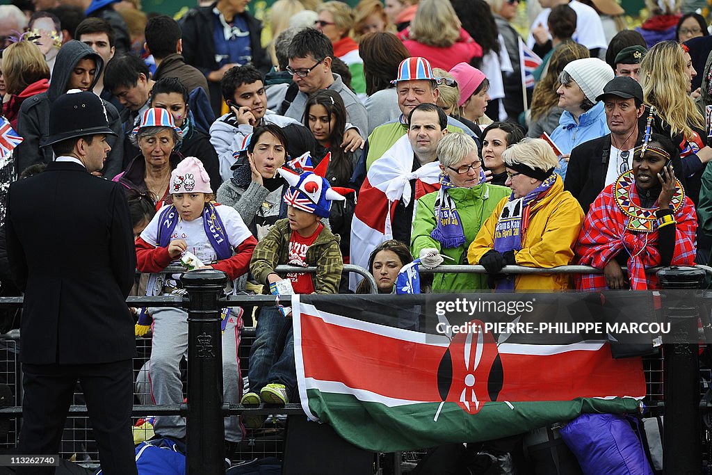 A woman dressed in a Masai costume (R) s